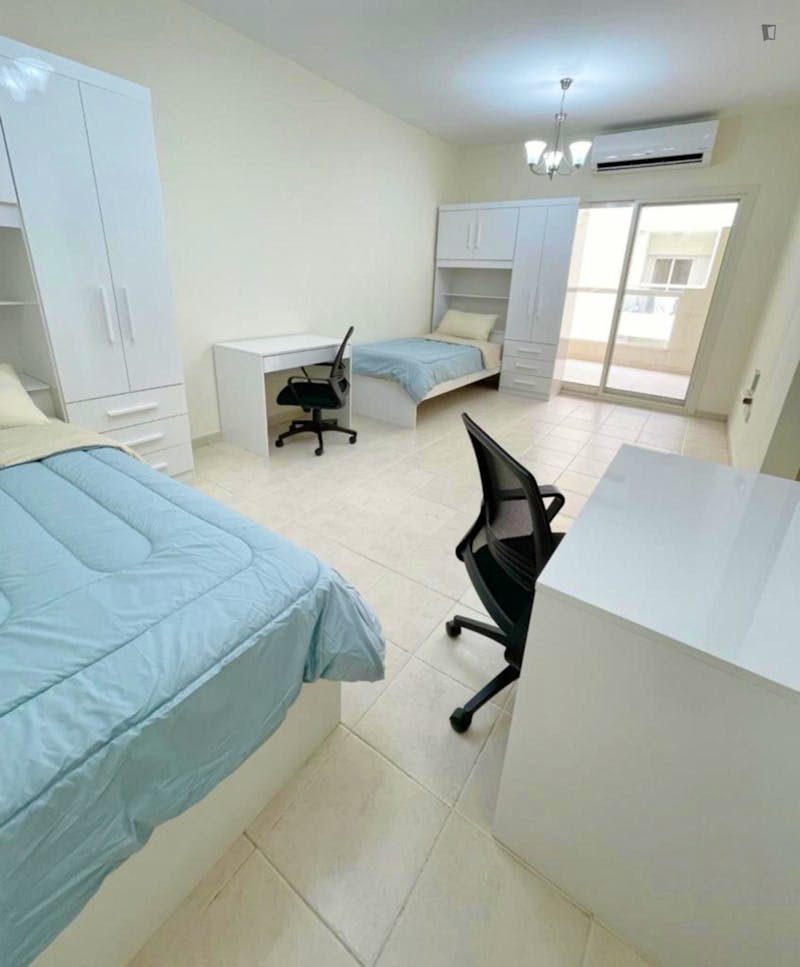 Bed in a luminous twin bedroom,  in a student building in Al Quoz Industrial Area 2